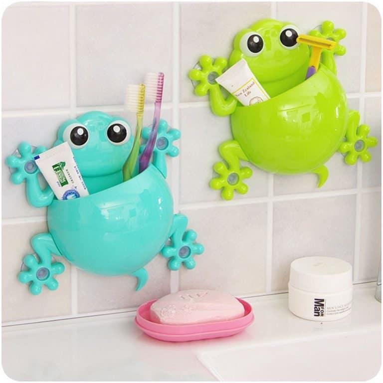 Bathroom wall with two frog-shaped bathroom accessory holders 